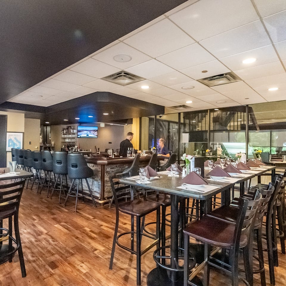 Cucina Vitale dining room and bar with tables set for dinner.